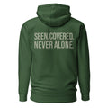 Seen. Covered. Never Alone. — Forest Green hoodie — back view